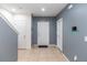 Townhome foyer features neutral tile flooring, a staircase, and a modern security system at 12827 Buffalo Run Dr, Gibsonton, FL 33534