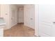 Upstairs hallway with carpet flooring and multiple closet doors for ample storage at 12827 Buffalo Run Dr, Gibsonton, FL 33534