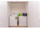 Enclosed laundry room with white washer and dryer, providing convenience and functionality at 12827 Buffalo Run Dr, Gibsonton, FL 33534