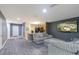 Spacious living room with comfortable seating, modern lighting, and a view into the adjacent kitchen at 12827 Buffalo Run Dr, Gibsonton, FL 33534