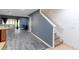 Open-concept living room featuring modern flooring and staircase leading to the next level at 12827 Buffalo Run Dr, Gibsonton, FL 33534