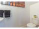 Neat powder room with a toilet and convenient cleaning supplies on display at 12827 Buffalo Run Dr, Gibsonton, FL 33534