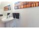 Elegant powder room featuring a pedestal sink and decorative wall art at 12827 Buffalo Run Dr, Gibsonton, FL 33534