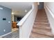 Carpeted staircase leading to the upper level, adjacent to an open concept kitchen at 12827 Buffalo Run Dr, Gibsonton, FL 33534