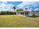 Large backyard with screened porch and lush lawn at 1518 W Dorchester Dr, Palm Harbor, FL 34684