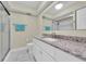 Clean bathroom with granite countertop and walk-in shower at 19029 Us Highway 19 N # 8-25, Clearwater, FL 33764
