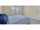 Cozy bedroom with a full-size bed and window view at 19029 Us Highway 19 N # 8-25, Clearwater, FL 33764