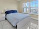 Bright bedroom with a comfortable bed and large window at 19029 Us Highway 19 N # 8-25, Clearwater, FL 33764