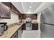 Galley kitchen with granite countertops and dark wood cabinets at 19029 Us Highway 19 N # 8-25, Clearwater, FL 33764