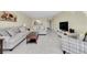 Open living room, dining area, and kitchen with tile floors at 19029 Us Highway 19 N # 8-25, Clearwater, FL 33764