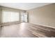 Living room with wood-look floors, neutral walls, and window at 2002 Australia E Way # 66, Clearwater, FL 33763