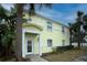 Bright yellow building exterior with palm trees and landscaping at 239 Seahorse Se Dr # B, St Petersburg, FL 33705