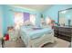 Light blue bedroom with a white bed frame and dark dresser at 2432 Lake Woodberry Cir # 2432, Brandon, FL 33510
