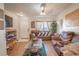 Spacious living room with brown leather couches and wood floors at 2432 Lake Woodberry Cir # 2432, Brandon, FL 33510