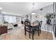 Charming dining area with wood table and four chairs, hardwood floors, and a view of the living room at 2436 Rhodesian Dr # 32, Clearwater, FL 33763