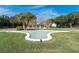 Star-shaped fountain with palm trees and lush landscaping at 2436 Rhodesian Dr # 32, Clearwater, FL 33763