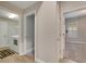 Hallway with laundry room and access to bedrooms at 2503 Centennial Falcon Dr, Valrico, FL 33596