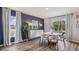 Modern dining room with round table, chairs, and a statement wall at 3443 Hilltop Cir, Lakewood Ranch, FL 34211