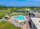 Community pool with surrounding patio furniture and golf course views at 3743 Teeside Dr, New Port Richey, FL 34655