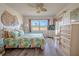 Bedroom with leafy bedding, wood-look floors and large window at 3743 Teeside Dr, New Port Richey, FL 34655