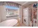 Laundry room with stackable washer and dryer, and a window at 3743 Teeside Dr, New Port Richey, FL 34655