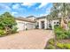 A beautiful two-story home with a three-car garage and manicured landscaping at 4825 Benito Ct, Bradenton, FL 34211