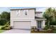 Two-story house with attached garage and landscaping at 5253 Salt Marsh Rd, Wimauma, FL 33598