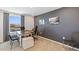 Modern home office with a large desk and gray accent wall at 5253 Salt Marsh Rd, Wimauma, FL 33598
