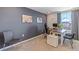 L-shaped desk in home office with gray walls and natural light at 5253 Salt Marsh Rd, Wimauma, FL 33598