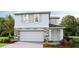 Two-story house with stone accents and a two-car garage at 5259 Salt Marsh Rd, Wimauma, FL 33598
