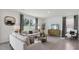 Spacious living room with light beige couches and a large TV at 5259 Salt Marsh Rd, Wimauma, FL 33598