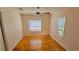 Simple bedroom with hardwood floors and two windows at 540 Newton S Ave, St Petersburg, FL 33701
