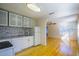 Modern kitchen with white cabinets and stone backsplash at 540 Newton S Ave, St Petersburg, FL 33701