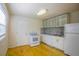 Updated kitchen with white appliances and hardwood floor at 540 Newton S Ave, St Petersburg, FL 33701