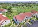 Aerial view of condo building with red tile roof and lush landscaping at 6059 Bahia Del Mar Blvd # 233, St Petersburg, FL 33715