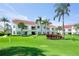 Two-story condo building with red tile roofs and lush landscaping at 6059 Bahia Del Mar Blvd # 233, St Petersburg, FL 33715