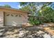 Attached garage with driveway and mature landscaping at 7014 21St N St, St Petersburg, FL 33702