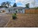 Newly renovated home with gray exterior, covered porch and a spacious driveway at 8912 N 39Th St, Tampa, FL 33604