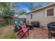 Brick patio with fire pit and colorful chairs at 944 Montrose N Blvd, St Petersburg, FL 33703