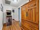 Bright hallway with wood floors, arcade game, and built-in storage at 944 Montrose N Blvd, St Petersburg, FL 33703