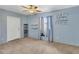 Light blue bedroom with neutral carpeting and a ceiling fan at 1040 31St E St, Palmetto, FL 34221