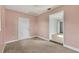 Small bedroom with light pink walls and neutral carpeting at 1040 31St E St, Palmetto, FL 34221