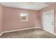 Small bedroom with light pink walls and neutral carpeting at 1040 31St E St, Palmetto, FL 34221