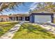 Ranch style home with a two-car garage and well-manicured lawn at 1040 31St E St, Palmetto, FL 34221
