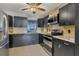 Dark-toned kitchen with stainless steel appliances and tile flooring at 1040 31St E St, Palmetto, FL 34221