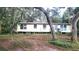 Mobile home exterior with mature trees. Needs renovation at 12403 Banbury Ave, New Port Richey, FL 34654