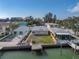 Aerial view of a waterfront property with a home and private dock at 12412 Lagoon Ln, Treasure Island, FL 33706