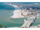 Aerial view of a beach, bridge, and coastal town at 12412 Lagoon Ln, Treasure Island, FL 33706