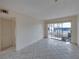 Bright living room with tiled floors and sliding glass doors at 12412 Lagoon Ln, Treasure Island, FL 33706