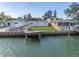 Waterfront property showcasing a home and private dock with water access at 12412 Lagoon Ln, Treasure Island, FL 33706